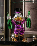 Billionaire Duck Dekoratif Ördek Biblo – Mor 40 cm, iki yeşil şampanya şişesi ve parlak emaye kaplamasıyla.